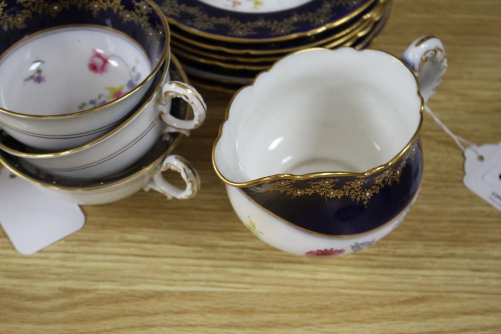 A Royal Worcester part tea service, painted with flower sprays by Ernest Phillips and Ernest Barker,